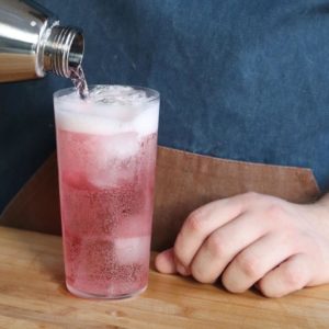 Añadiendo soda al cóctel Kalimotxo rosado